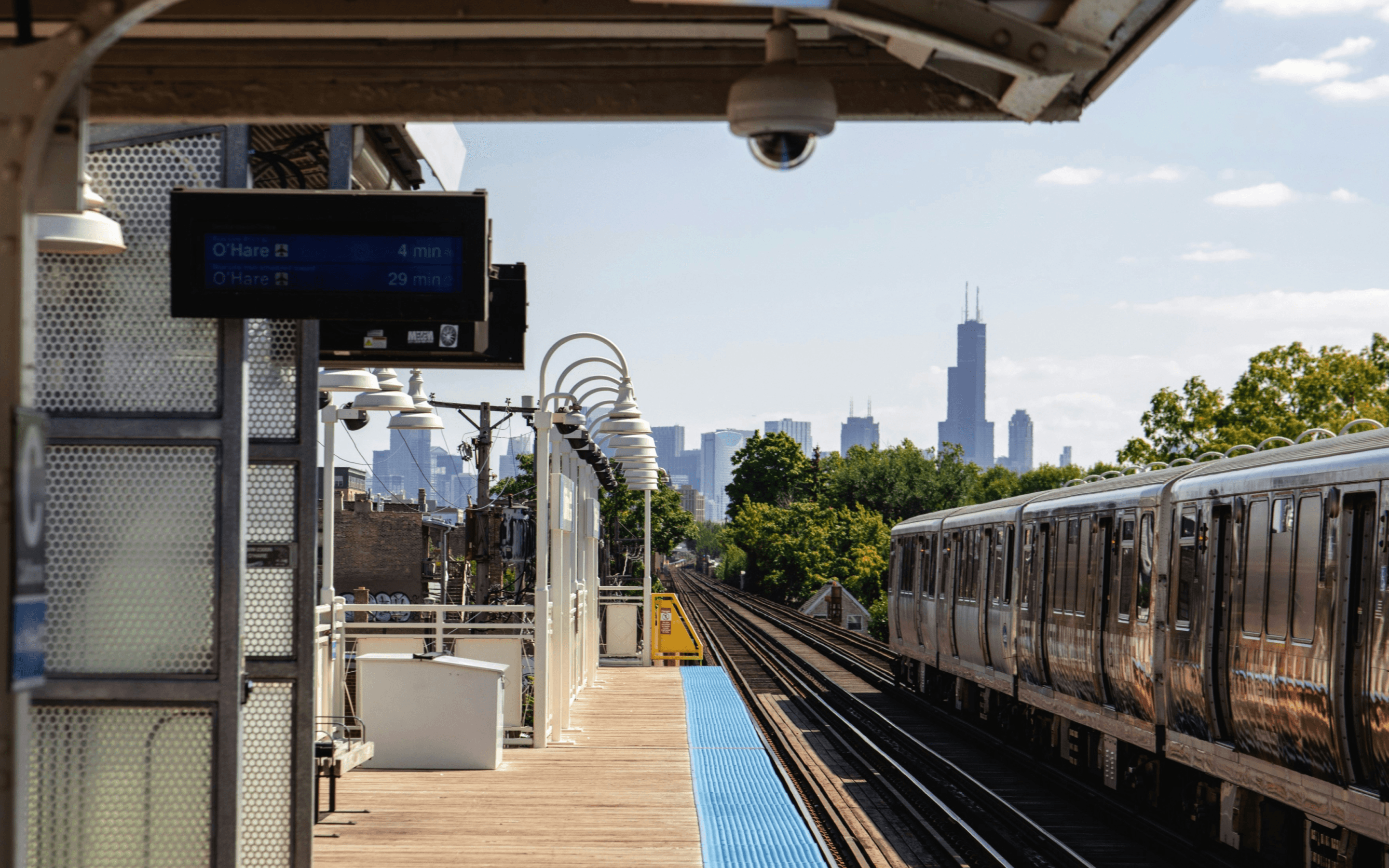 Chicago skyline with CTA elevated train representing CO2 savings from public transit ridership
