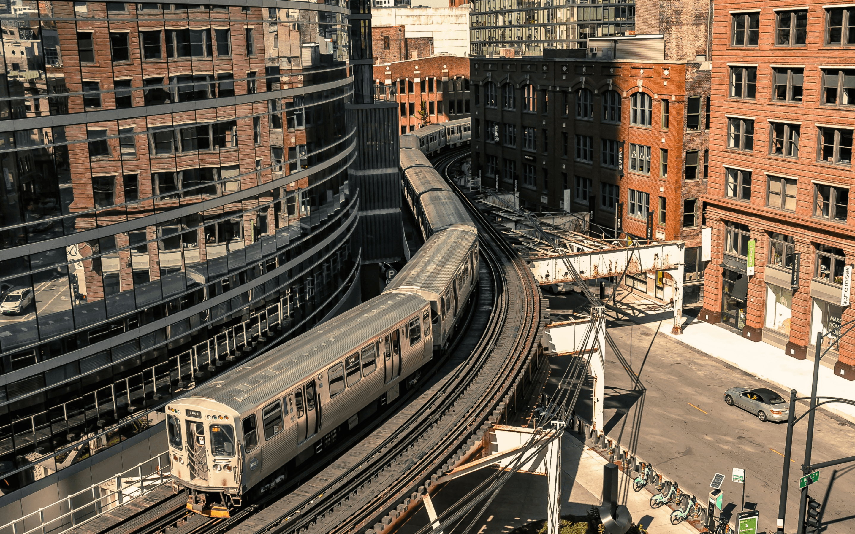Riders boarding a CTA bus in Chicago with the downtown skyline in the background